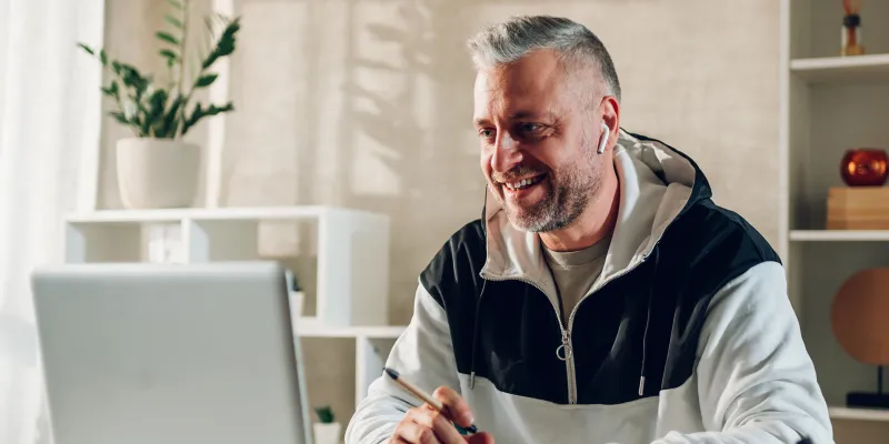 Adult Male with Earbuds on Laptop