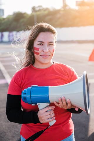 Woman with painted face holding megaphone