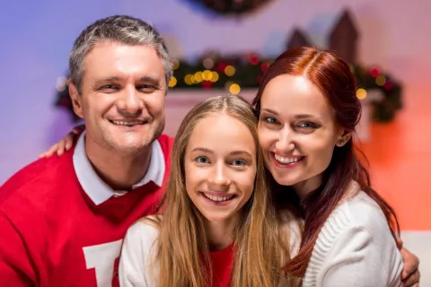 Smiling young teen girl with mother and father