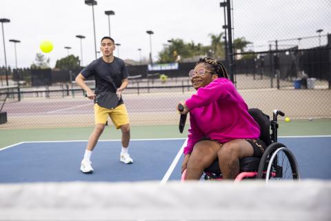 African American woman in wheelchair playing pickle ball