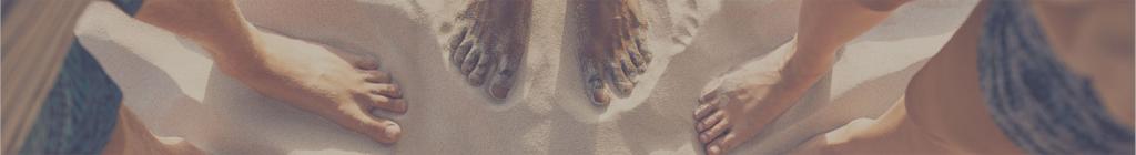 Bare feet in the sand from above