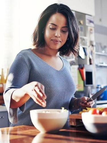 Woman prepping food in kitchen