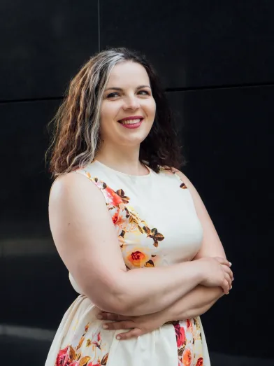 Smiling young woman in flowered dress