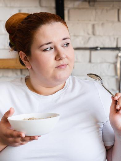 Woman looking pensive while eating