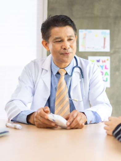 Asian American physician talking to patient