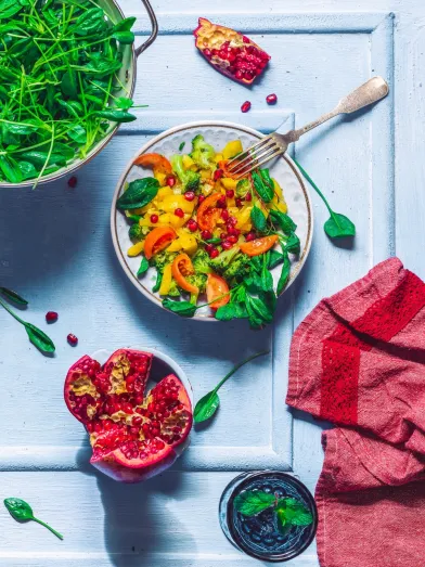 Salad on plate with pomegranate