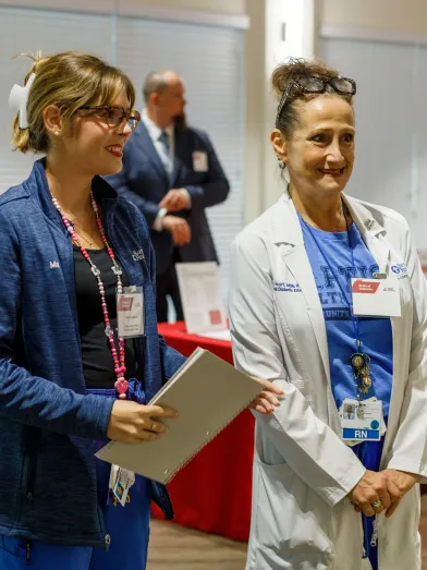 Healthcare professionals smiling and talking at an ADA event.