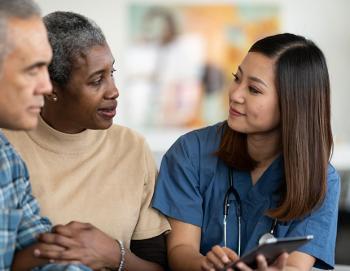 African American couple talking to Asian woman health care worker