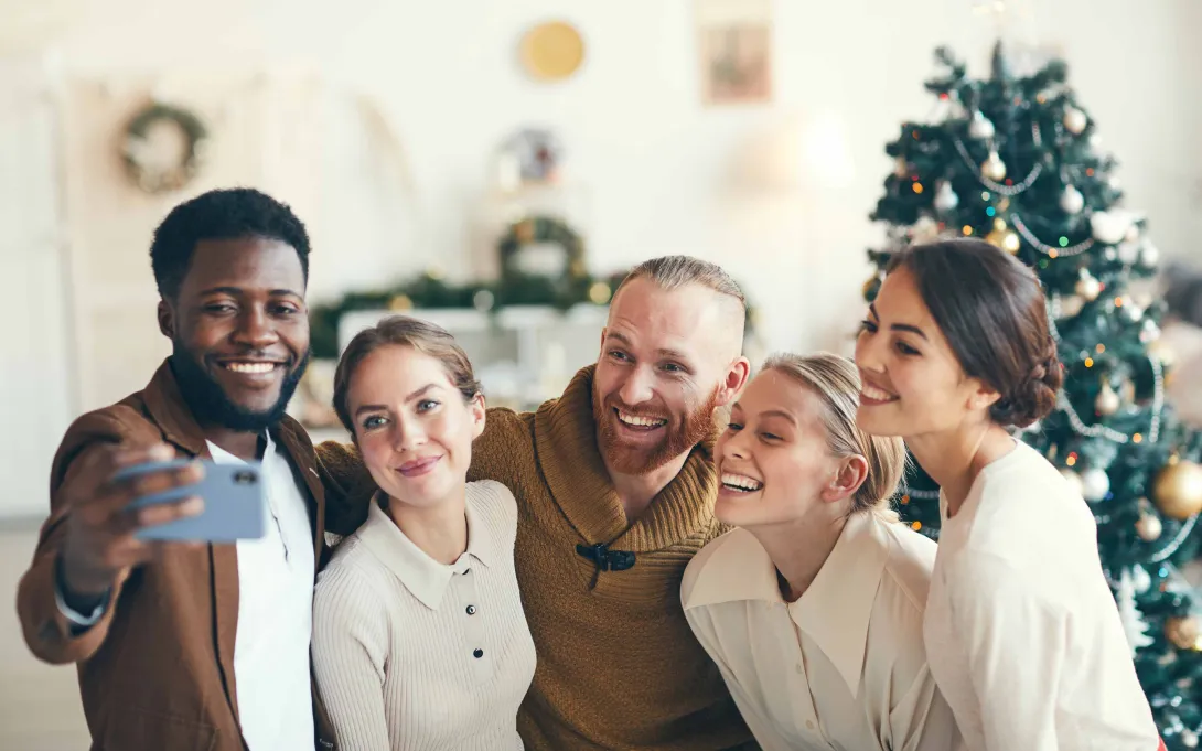 Group of people taking a selfie for the holidays